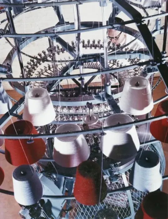 Framed Print : A machine collects coloured yarn onto rolls