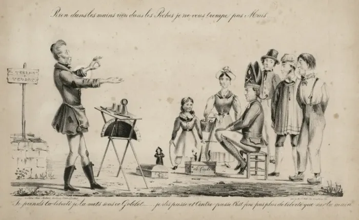 Framed Print : Magician performing the cup and balls trick to a small crowd Framed Print : Magician performing the cup and balls trick to a small crowd