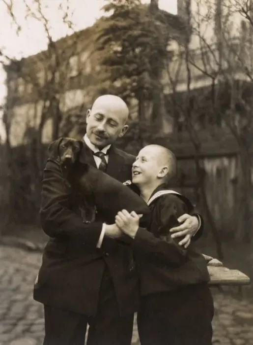 Framed Print : Man and boy holding a dachshund Framed Print : Man and boy holding a dachshund