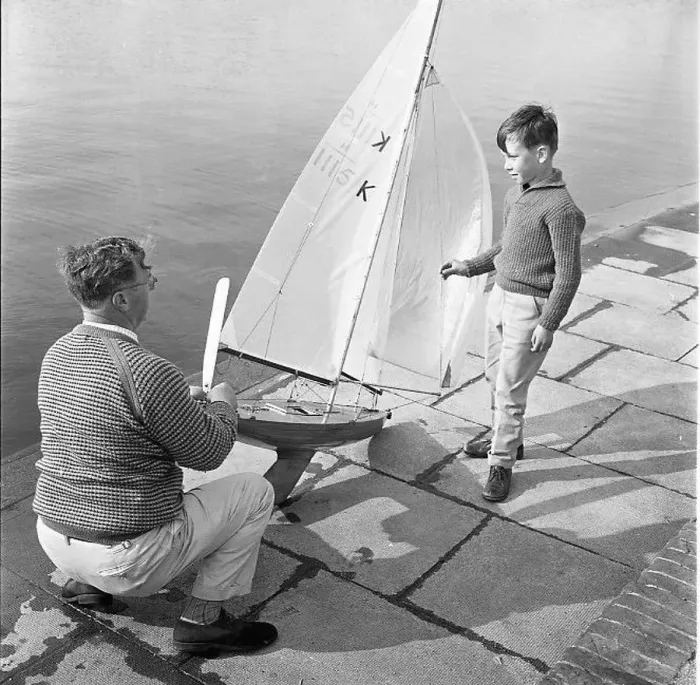 : Man and boy with model sailing boat : Man and boy with model sailing boat