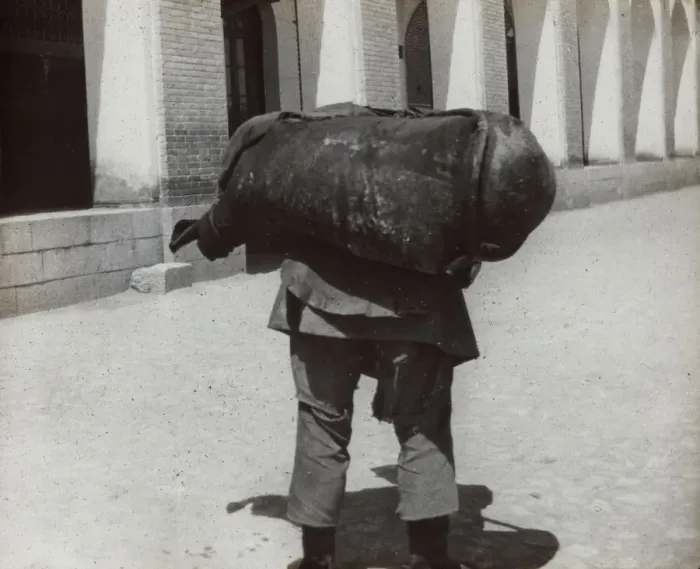 Framed Print : Man carrying a heavy weight Framed Print : Man carrying a heavy weight