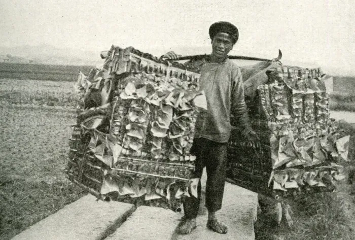 Framed Print : Man carrying imitation paper money, China, East Asia Framed Print : Man carrying imitation paper money, China, East Asia