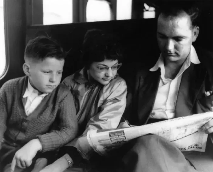 Framed Print : Man and two children doing the crossword on a train Framed Print : Man and two children doing the crossword on a train