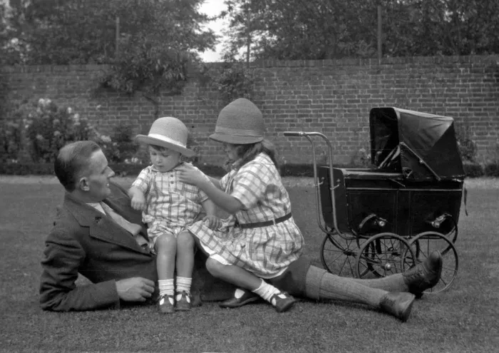 Framed Print : Man with two children and a toy pram Framed Print : Man with two children and a toy pram