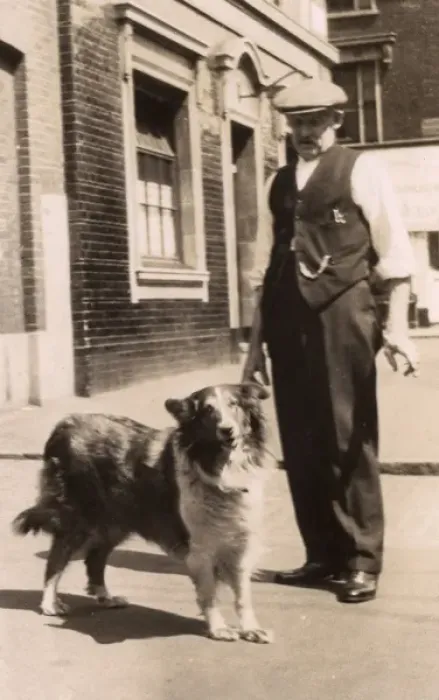 Framed Print : Man with a collie dog in a street Framed Print : Man with a collie dog in a street