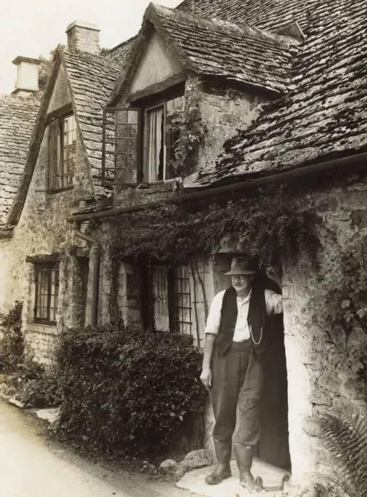 Framed Print : Man in cottage doorway, Arlington Row, Bibury, Glos Framed Print : Man in cottage doorway, Arlington Row, Bibury, Glos