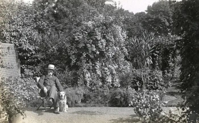 Framed Print : Man in deckchair with pet dog Framed Print : Man in deckchair with pet dog