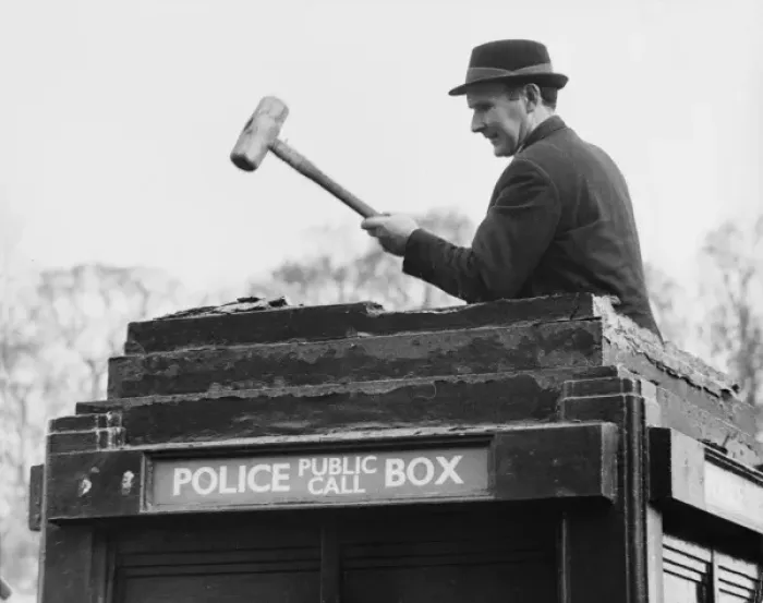 Framed Print : Man demolishing top of police public call box Framed Print : Man demolishing top of police public call box