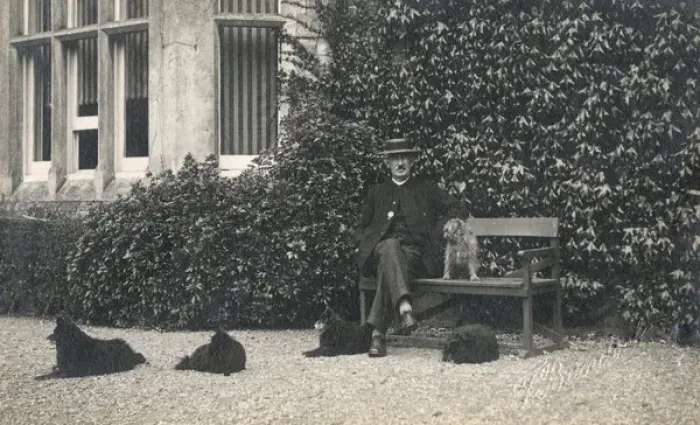 Framed Print : Man and four dogs outside a large house Framed Print : Man and four dogs outside a large house