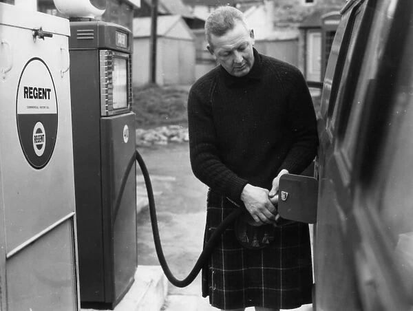 Man in a kilt, filling a van up with petrol