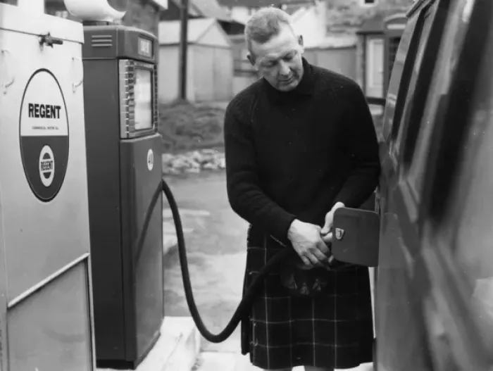 Framed Print : Man in a kilt, filling a van up with petrol Framed Print : Man in a kilt, filling a van up with petrol