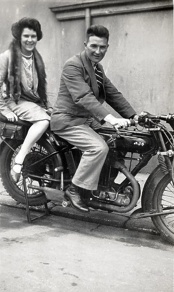 Man & lady on a 1926  /  7 AJS motorcycle