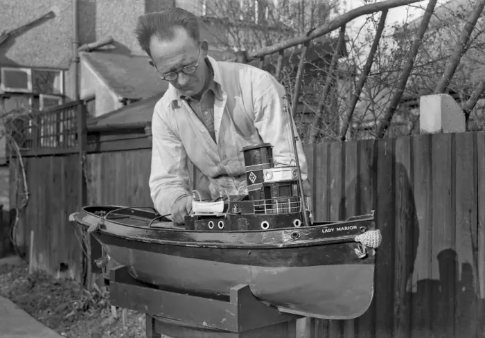 Framed Print : Man making model boat in garden Framed Print : Man making model boat in garden