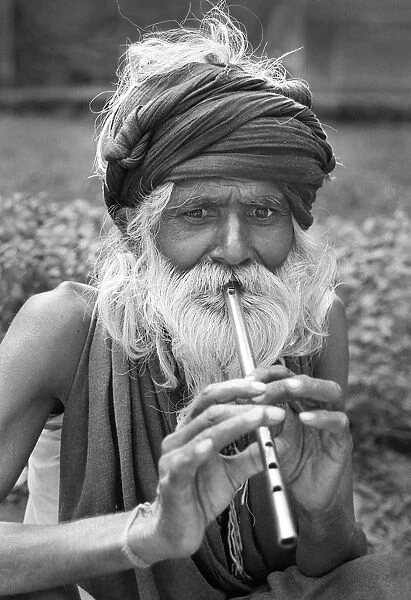 Man playing tin whistle, Agra, India - 2