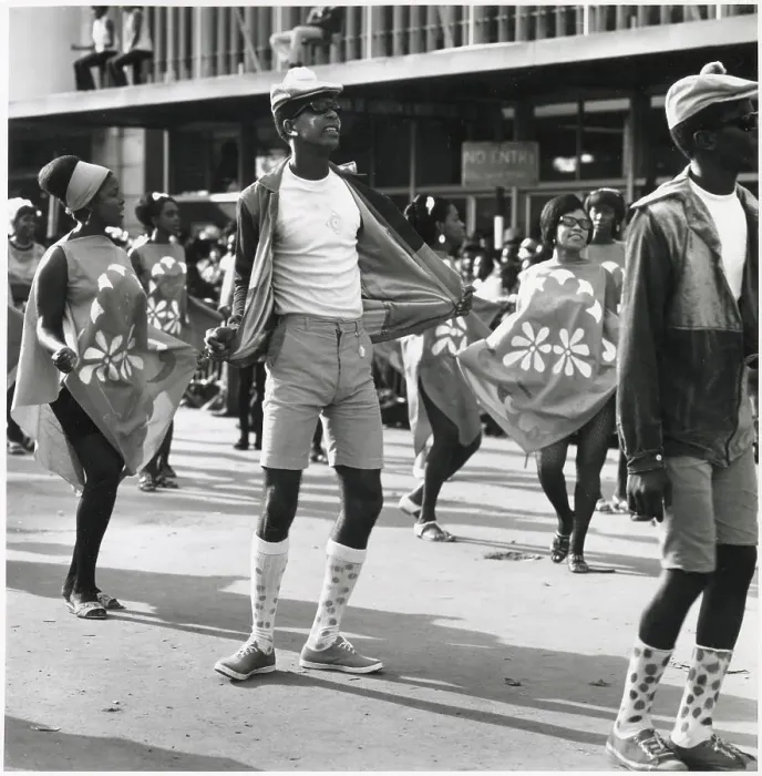 Framed Print : A man in shorts and long socks dances between two fashionable women at the Port of Spain Carnival, Trinidad, West Indies. Date: 1968 Framed Print : A man in shorts and long socks dances between two fashionable women at the Port of Spain Carnival, Trinidad, West Indies. Date: 1968