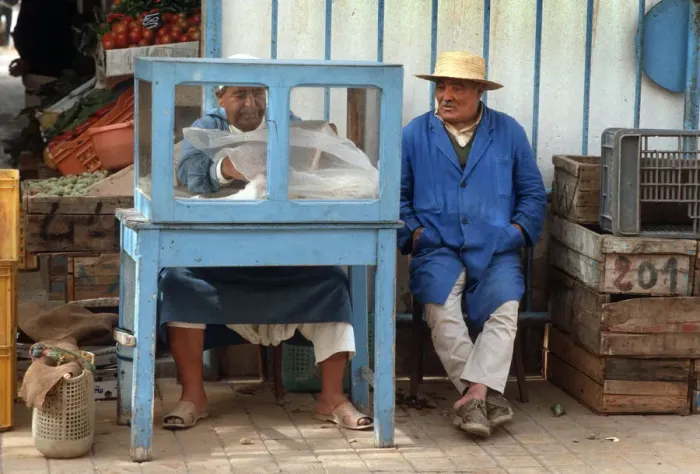 Framed Print : Man sits beside a small food stall in Houmt Souk, Djerba Framed Print : Man sits beside a small food stall in Houmt Souk, Djerba