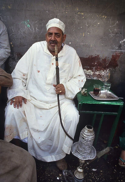 A man sits in a back street tea shop in Cairo, Egypt