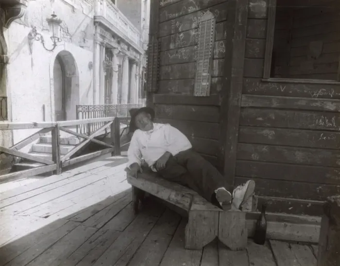 Framed Print : Man sleeping on a bench in a side street, Venice, Italy Framed Print : Man sleeping on a bench in a side street, Venice, Italy