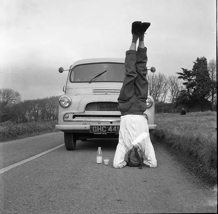 : Man standing on his head in the road : Man standing on his head in the road
