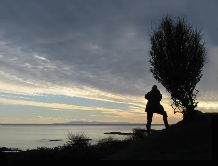 Framed Print : A man takes a photograph of the Isle of Man from Knockbrex
