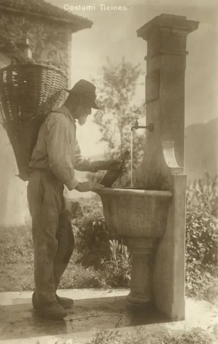 Framed Print : A Man of Ticino re-fills his water bottle - Switzerland Framed Print : A Man of Ticino re-fills his water bottle - Switzerland