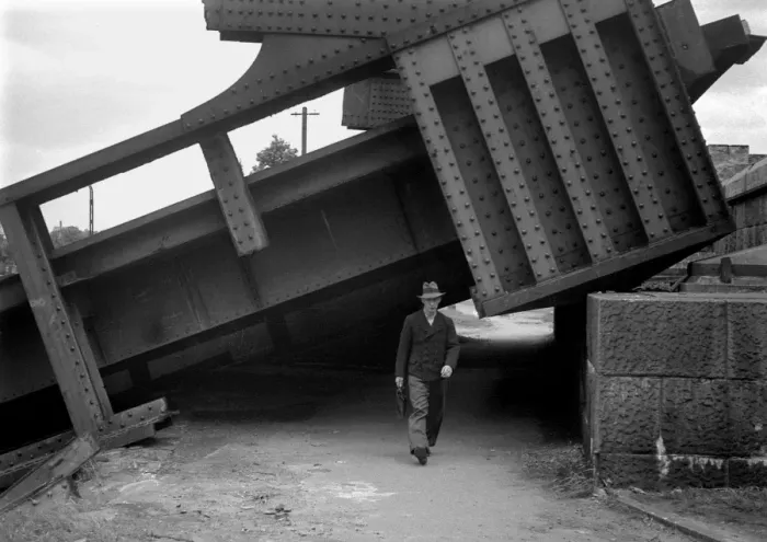 Framed Print : Man walking under collapsed structure, WW2 Framed Print : Man walking under collapsed structure, WW2