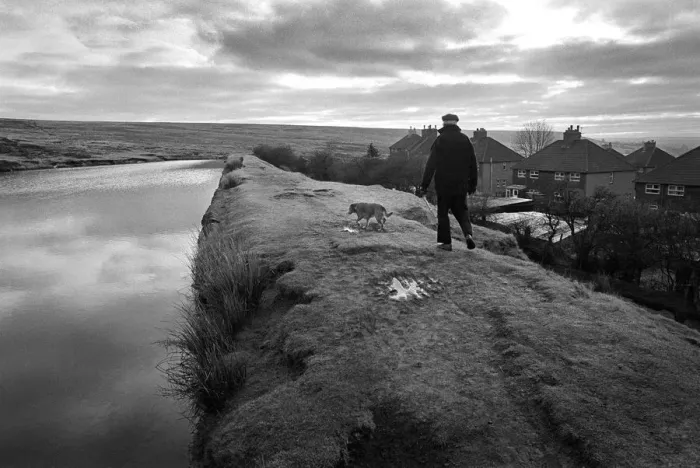 Framed Print : A man walks his dog along an embankment in Blaenavon, Wales Framed Print : A man walks his dog along an embankment in Blaenavon, Wales