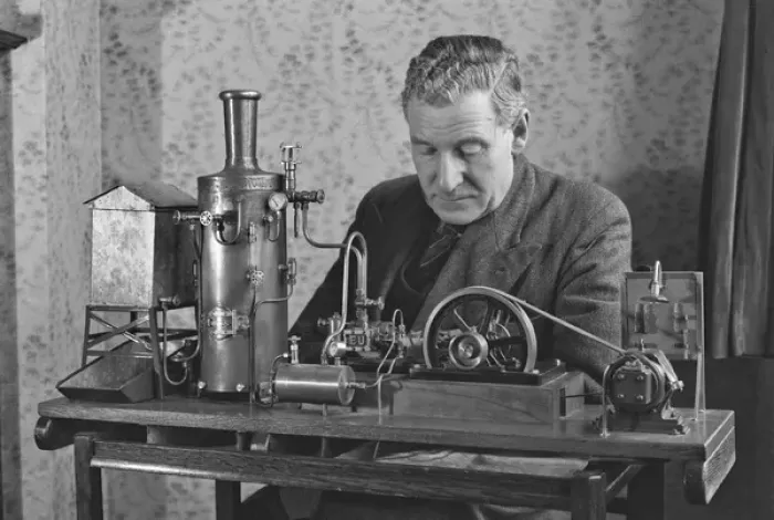 Framed Print : Man working on miniature steam engine Framed Print : Man working on miniature steam engine