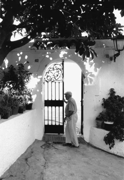 Framed Print : Man at a wrought iron gate, Spain Framed Print : Man at a wrought iron gate, Spain