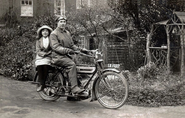 Man & young girl on a 1911 Triumph motorcycle