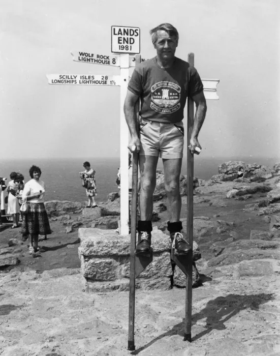 Framed Print : Marathon stilt walker at Lands End, Cornwall Framed Print : Marathon stilt walker at Lands End, Cornwall