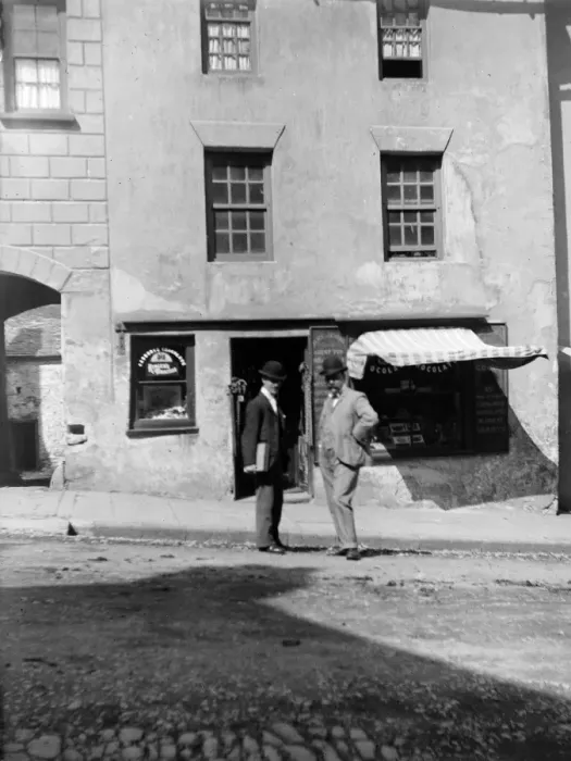 Framed Print : Men outside shop, High Street, Haverfordwest, South Wales Framed Print : Men outside shop, High Street, Haverfordwest, South Wales