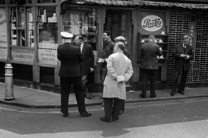 Framed Print : Men outside a snack bar see something amusing Framed Print : Men outside a snack bar see something amusing