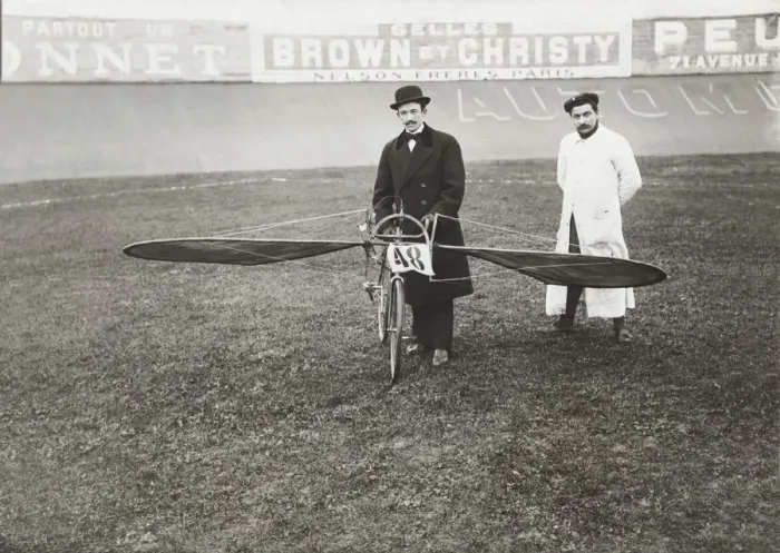 Framed Print : Men Standing with Bi-Cycle Aircraft with Adverts in Fren? Framed Print : Men Standing with Bi-Cycle Aircraft with Adverts in Fren?