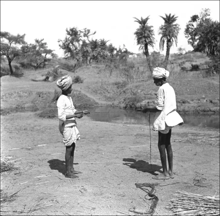 Framed Print : Two Men tie reeds by a stream Framed Print : Two Men tie reeds by a stream