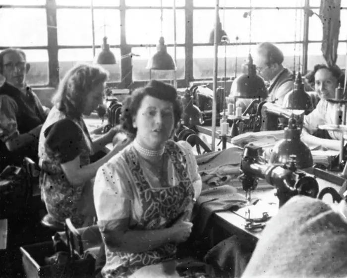 Framed Print : Men and women in a tailors workshop Framed Print : Men and women in a tailors workshop
