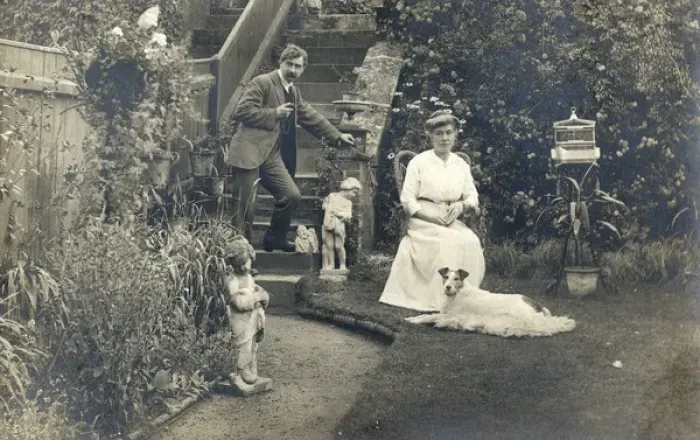 Framed Print : Middle aged couple and a dog in a garden Framed Print : Middle aged couple and a dog in a garden