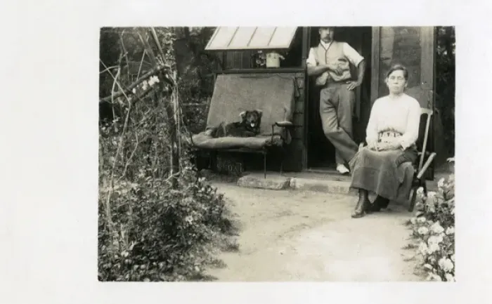 Framed Print : Middle aged couple in back yard with dog Framed Print : Middle aged couple in back yard with dog