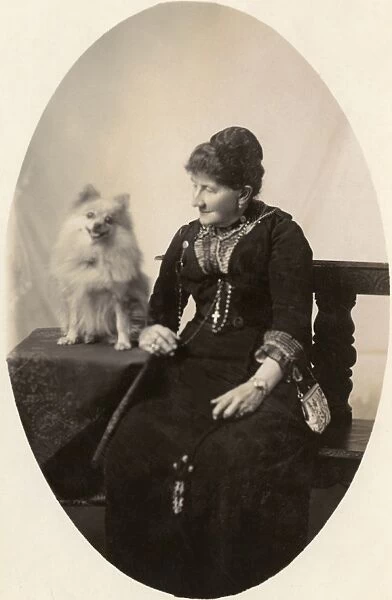 Middle aged woman with dog in studio photo