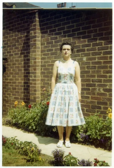 Framed Print : Middle aged woman on a path in a suburban British garden Framed Print : Middle aged woman on a path in a suburban British garden