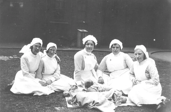 Midwives and babies, outdoors
