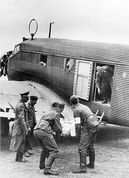 A military Junkers Ju52  /  3m being loaded with a casualty