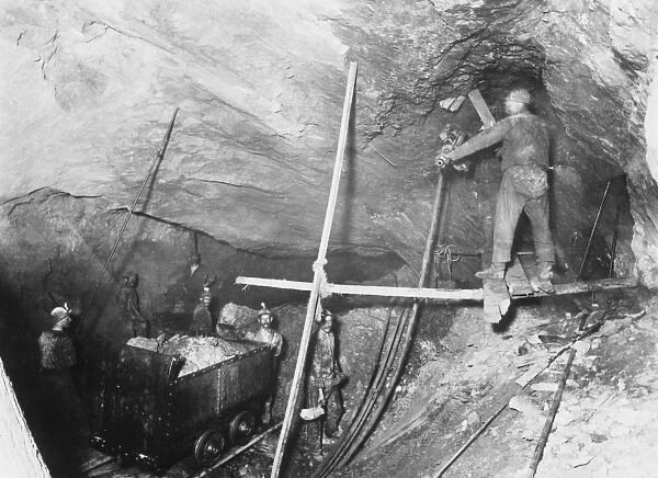 Miners loading a mine car in a coal mine in America