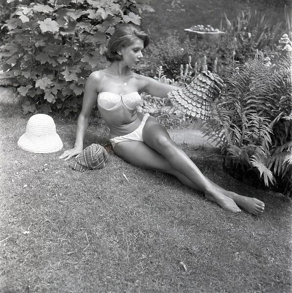 Model sunbathing in a white bikini