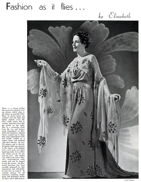 Model wearing a floral maternity evening gown 1937