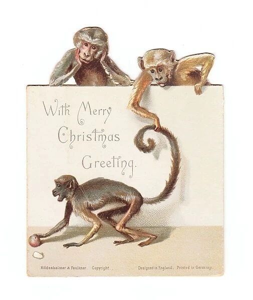 Three monkeys on a cutout Christmas card