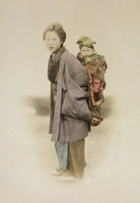 Framed Print : Mother carrying child on her back Framed Print : Mother carrying child on her back