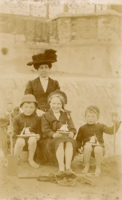 Framed Print : Mother and her three children, each holding a toy boat Framed Print : Mother and her three children, each holding a toy boat