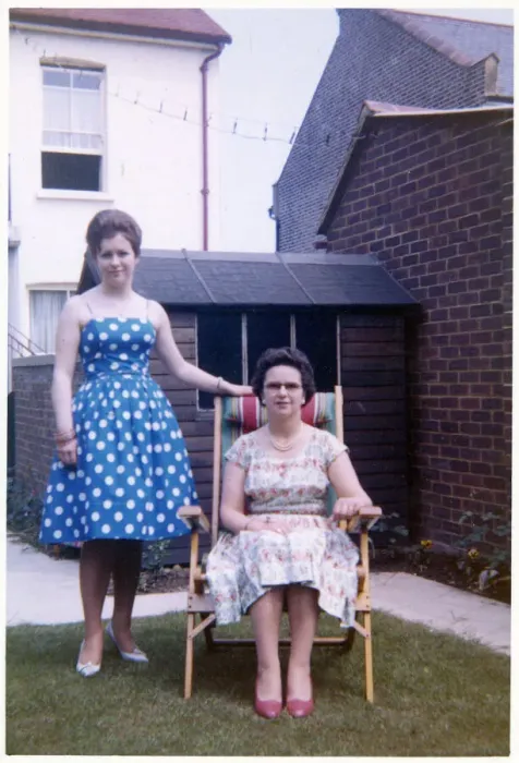 Framed Print : Mother and daughter in a neat suburban back garden - summer