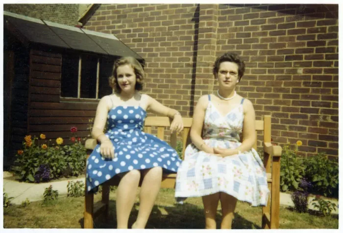 Framed Print : Mother and daughter in summer dresses on a garden bench Framed Print : Mother and daughter in summer dresses on a garden bench
